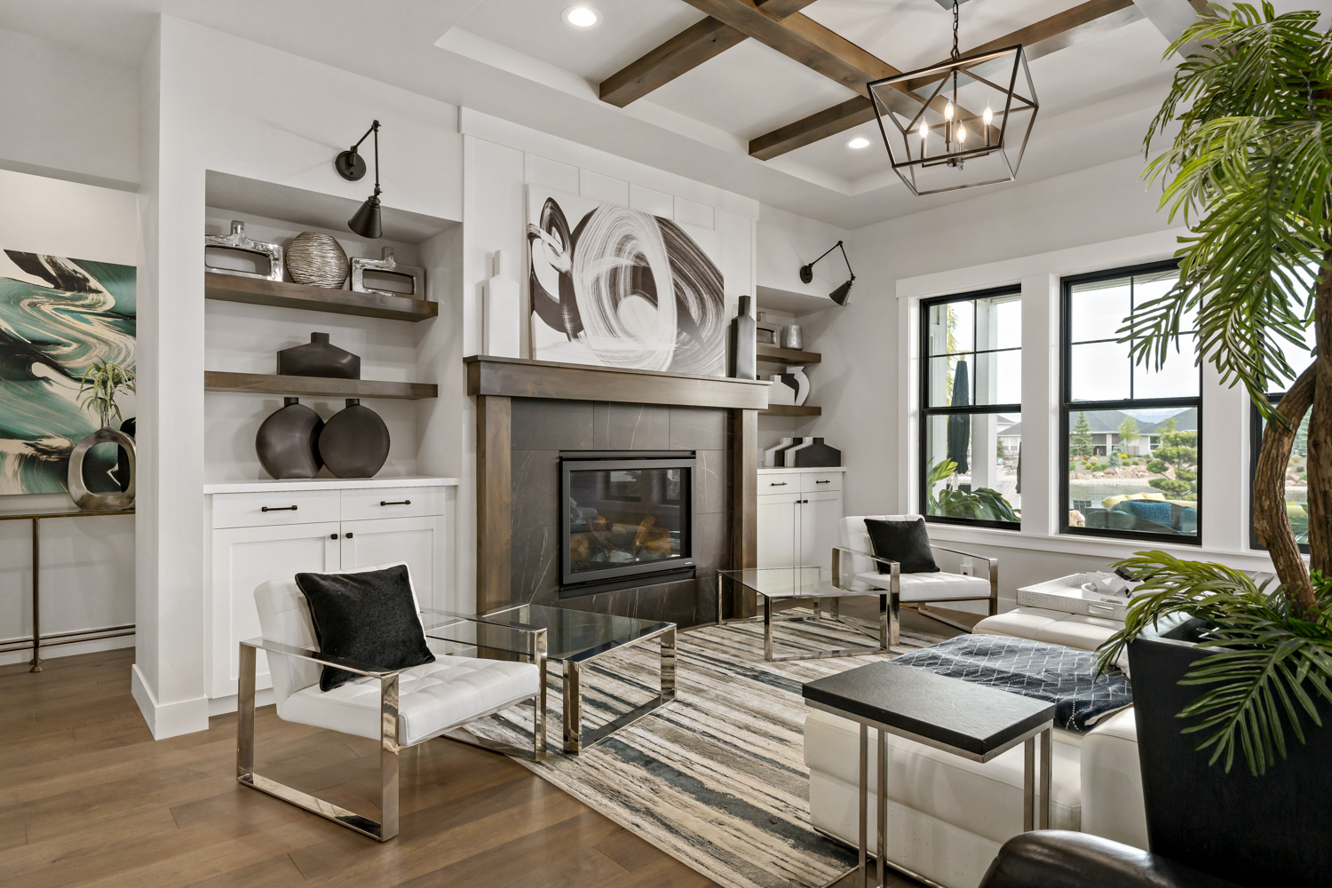 Stylish living room interior with stone fireplace, built-in shelving, and exposed beam ceiling