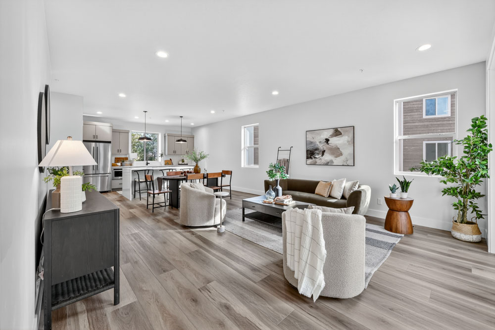 Interior open-concept living room and kitchen with modern decor and hardwood floors in Boise Idaho