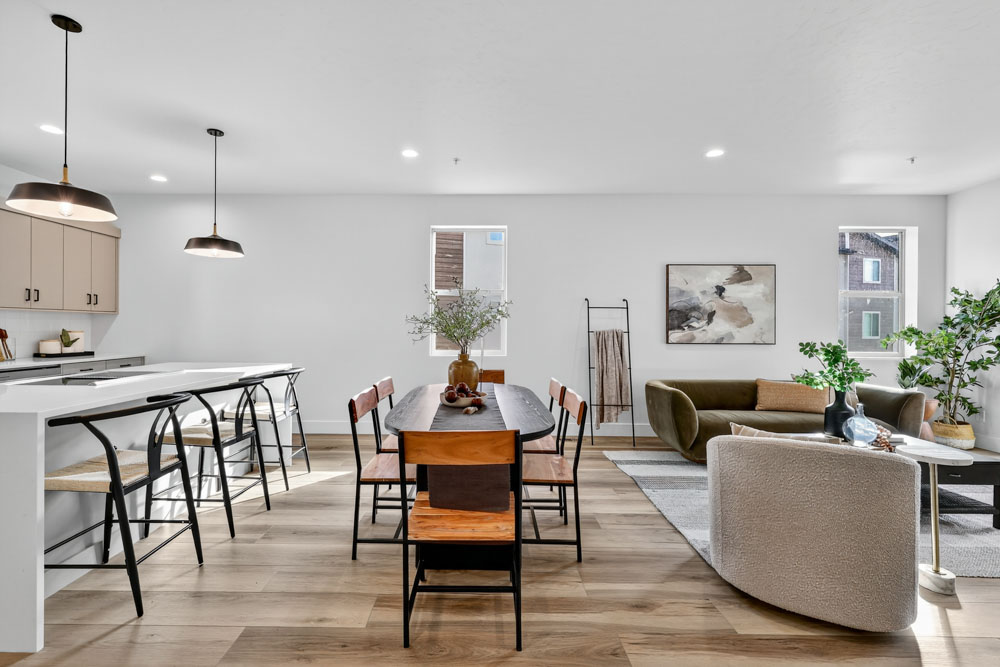 Interior open dining and living area with modern furnishings and kitchen island in Boise home
