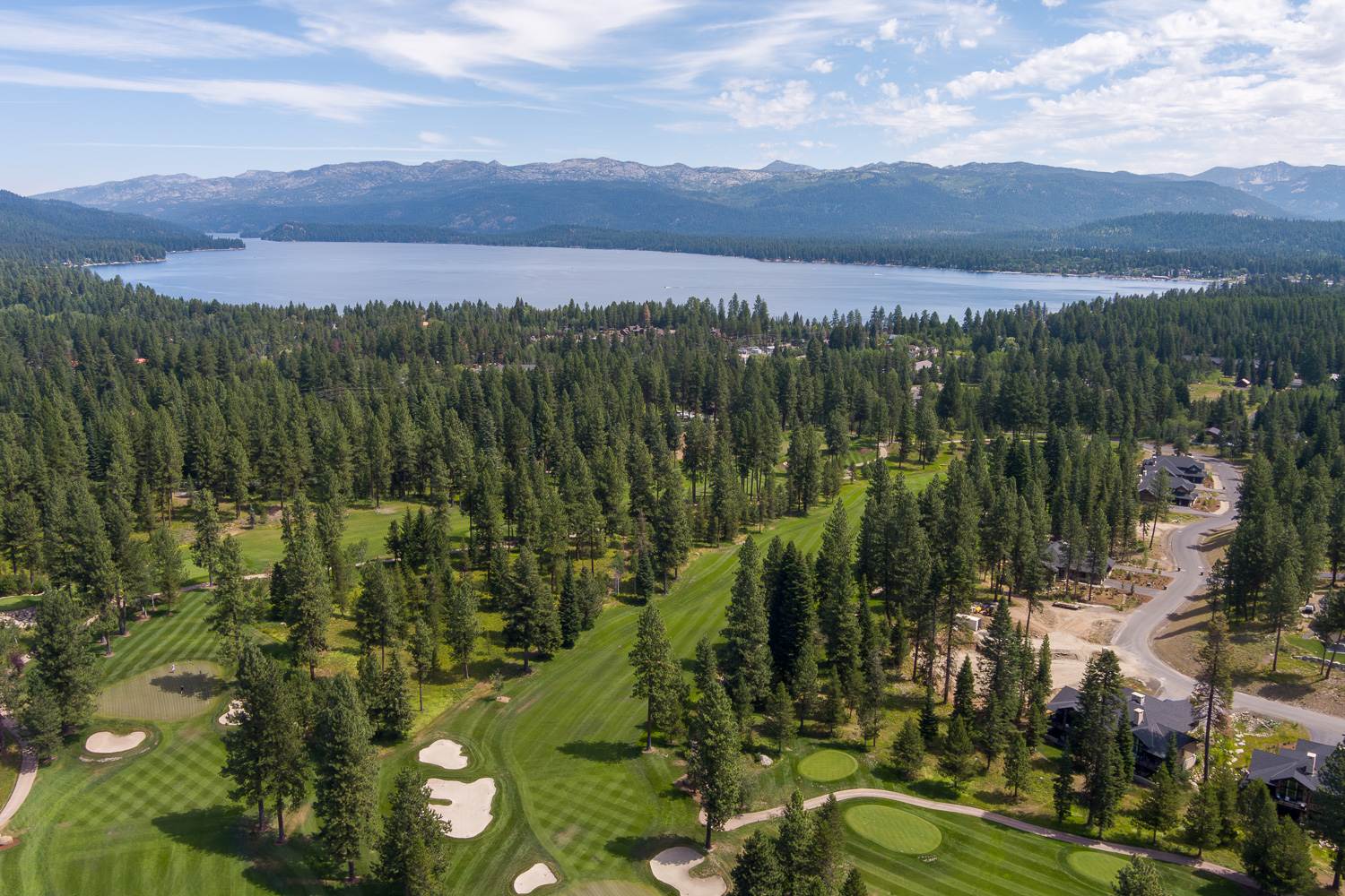 Aerial view of McCall Idaho golf course community surrounded by pine trees at sunset
