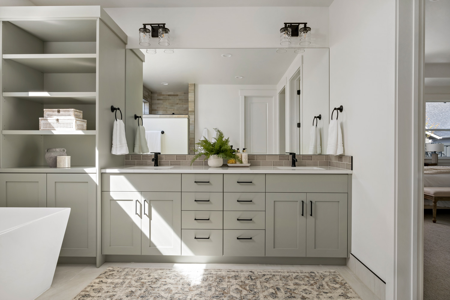 Bright white kitchen with large island and pendant lights in Boise Idaho model home