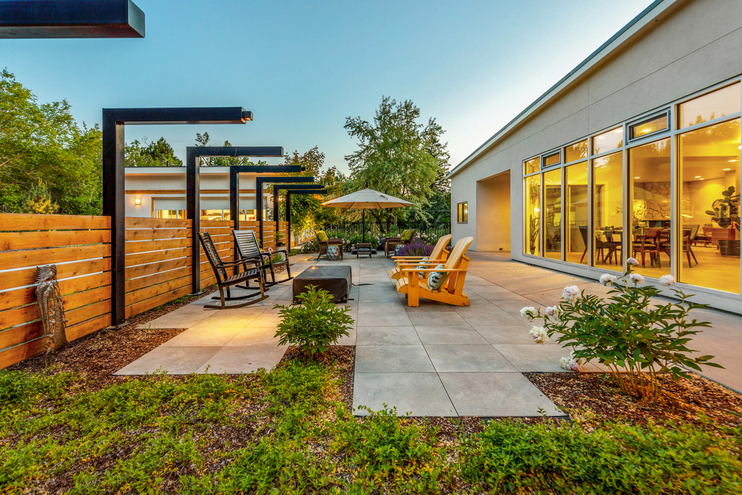 Covered outdoor patio with pool and lounge seating at Boise Idaho luxury home