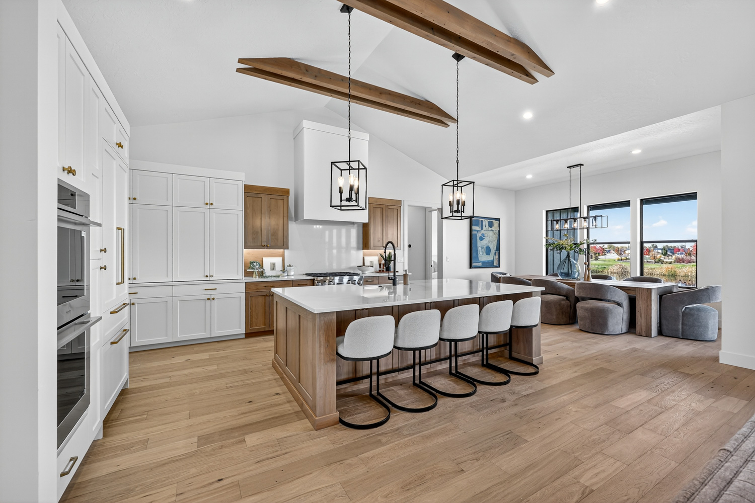 Open concept great room with wood beam ceiling and modern finishes in Boise Idaho