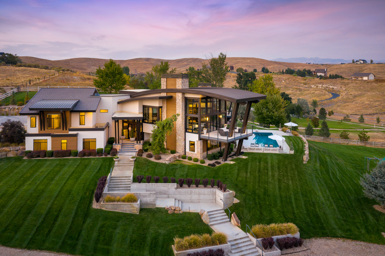 Aerial sunset drone view of luxury estate with green lawn in Boise Idaho
