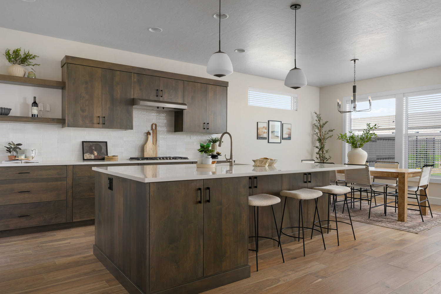 Modern kitchen with island bar seating and open floor plan in Boise Idaho home