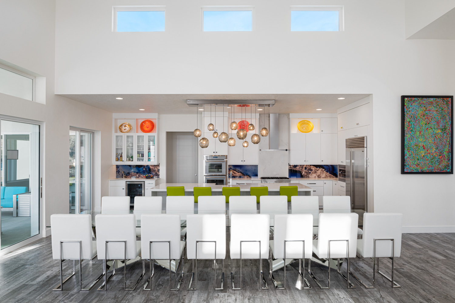 Contemporary open-concept living and dining room with dark floors in luxury Boise home