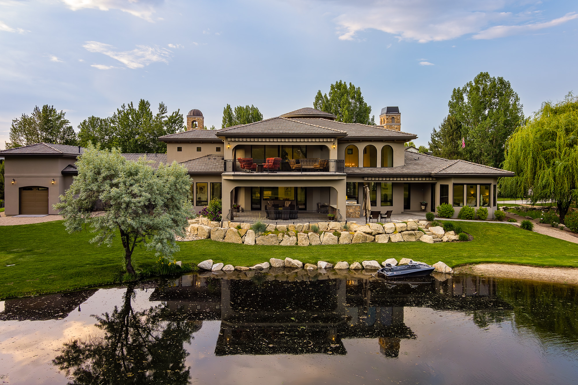 Aerial view of Mediterranean estate with pond and landscaped grounds in Idaho
