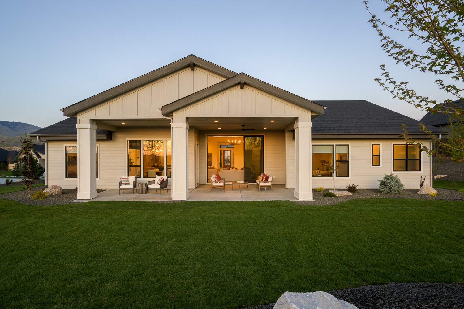 Modern home exterior with wood and stone accents at dusk in Eagle Boise Idaho