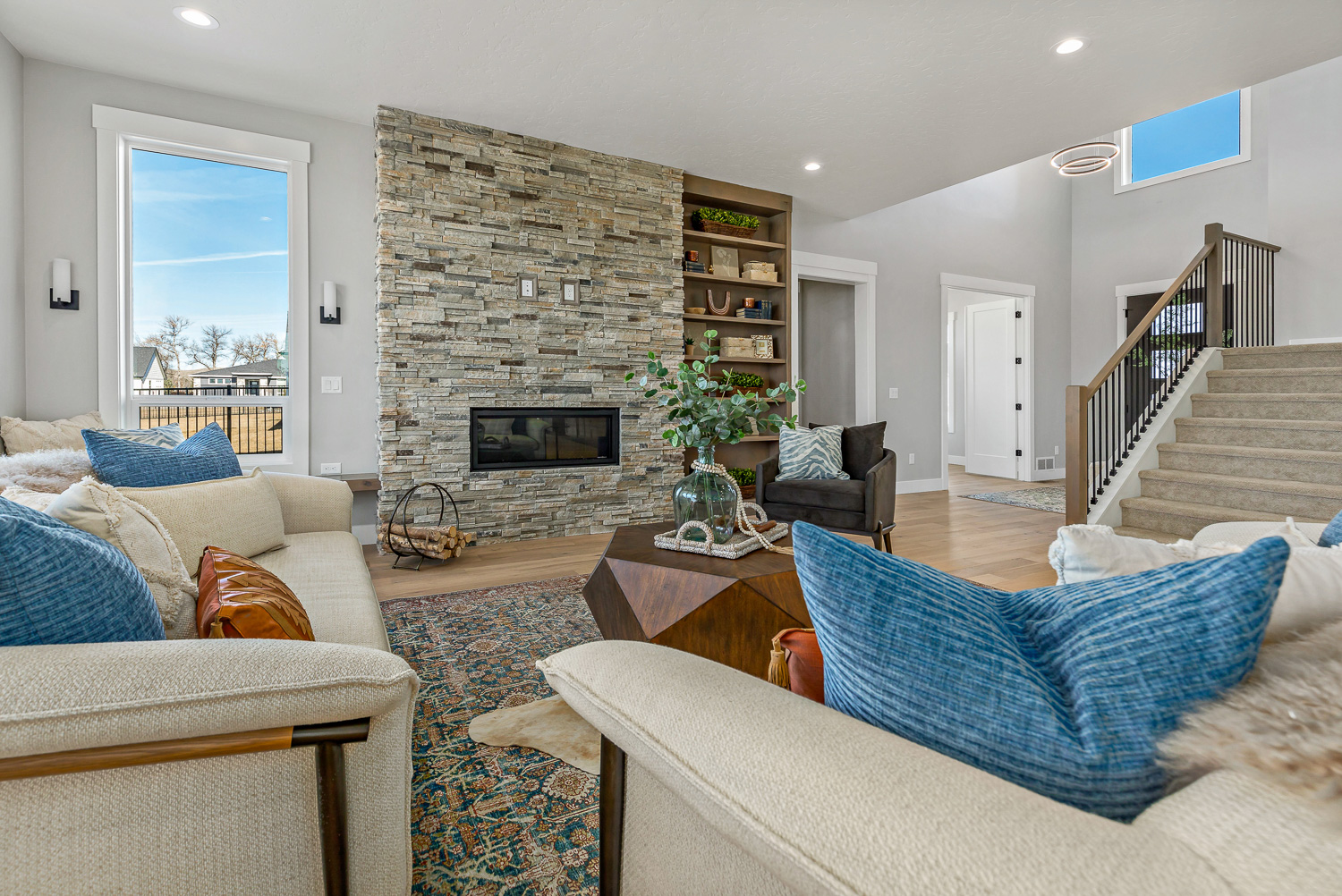 Grand living room with wood beams and large fireplace in Eagle Idaho estate