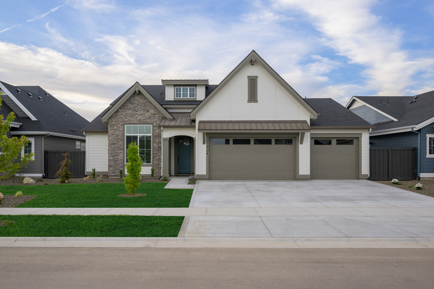 Elegant luxury estate with manicured lawn and outdoor lighting at dusk in Eagle Idaho
