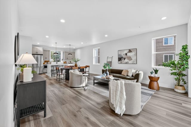 Interior open-concept living room and kitchen with modern decor and hardwood floors in Boise Idaho