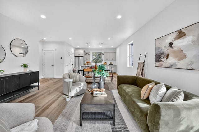 Open-concept living room interior with staged furniture, hardwood floors, and kitchen view in Boise Idaho