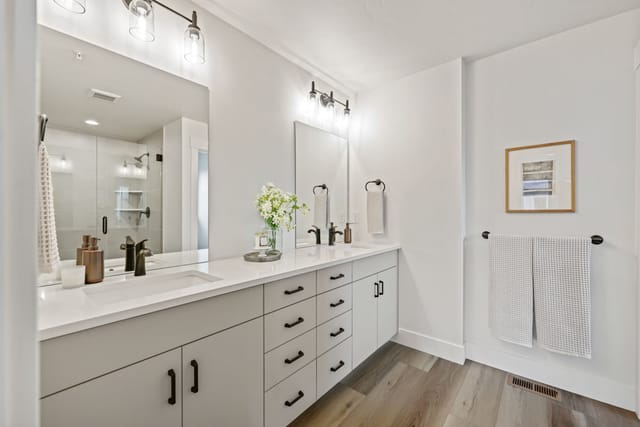 Interior master bathroom with double vanity, white quartz counters, and black hardware in Boise Idaho