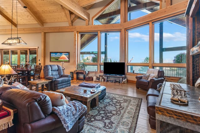 Rustic timber frame great room interior with vaulted ceilings and panoramic Idaho views