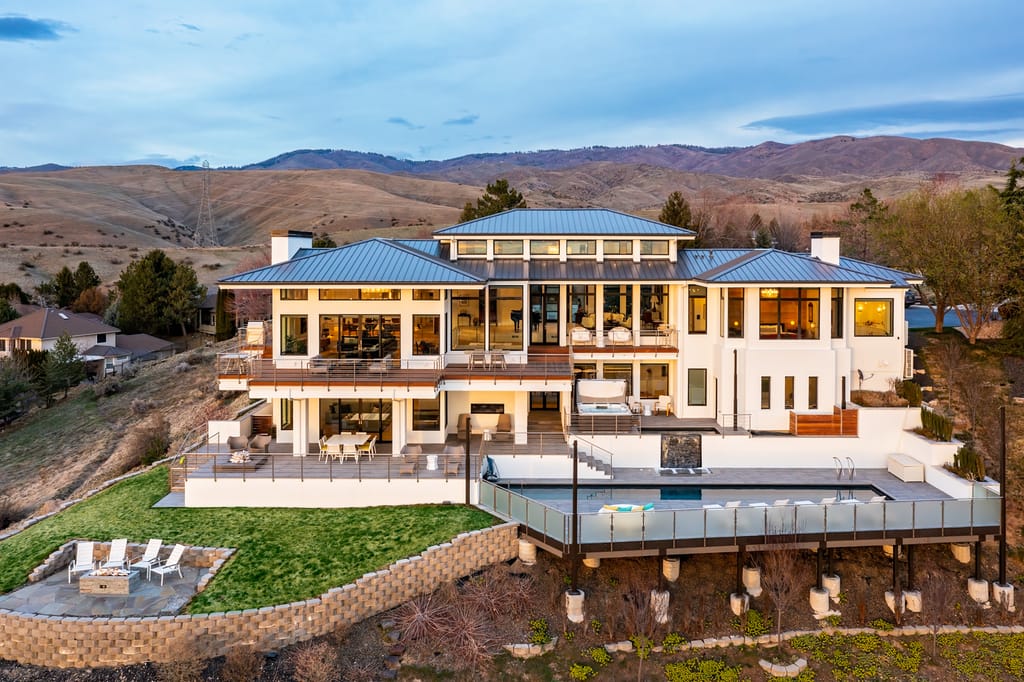Luxury home with pool and landscaped backyard at twilight in Boise Idaho