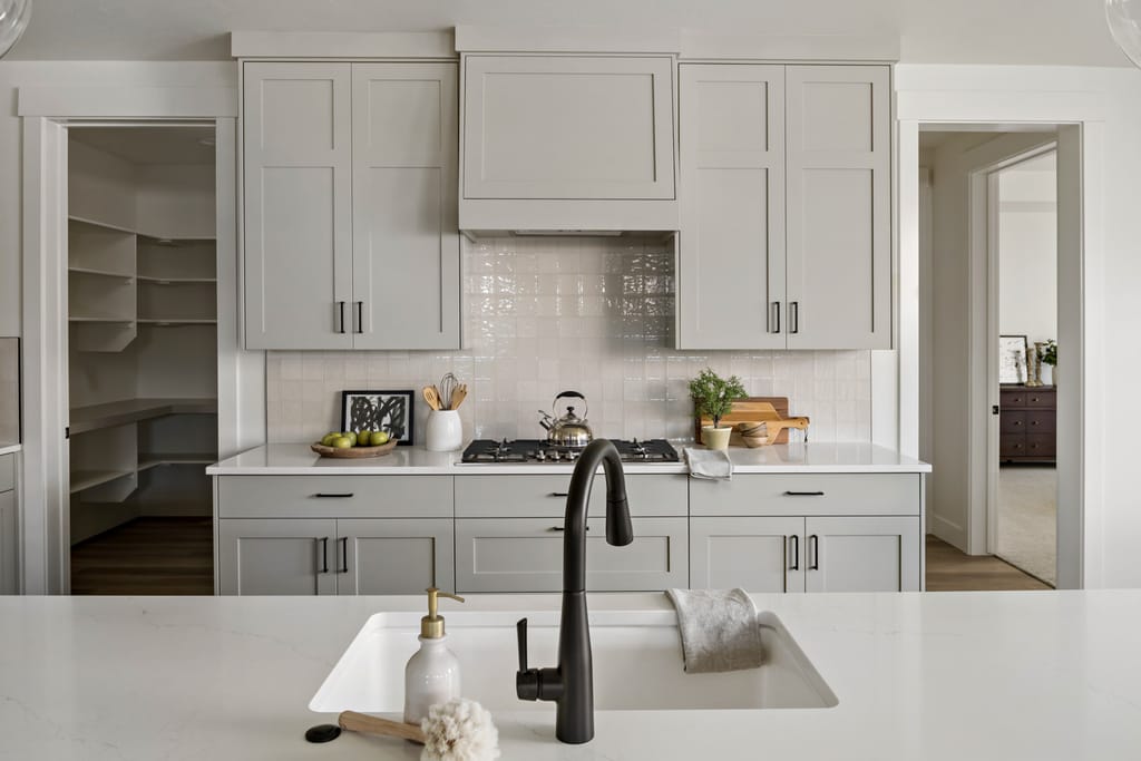 Master bathroom with black fixtures and white tile in modern Boise Idaho home