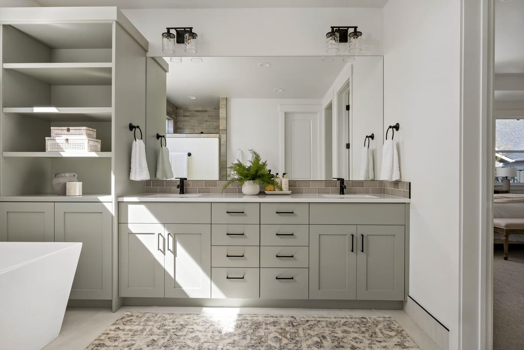 Bright white kitchen with large island and pendant lights in Boise Idaho model home