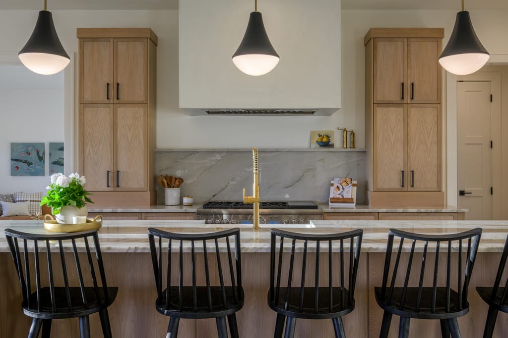 Covered patio dining area with pendant lights at Bennett Valley home in Boise Idaho