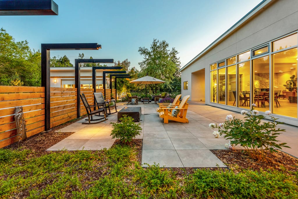 Covered outdoor patio with pool and lounge seating at Boise Idaho luxury home