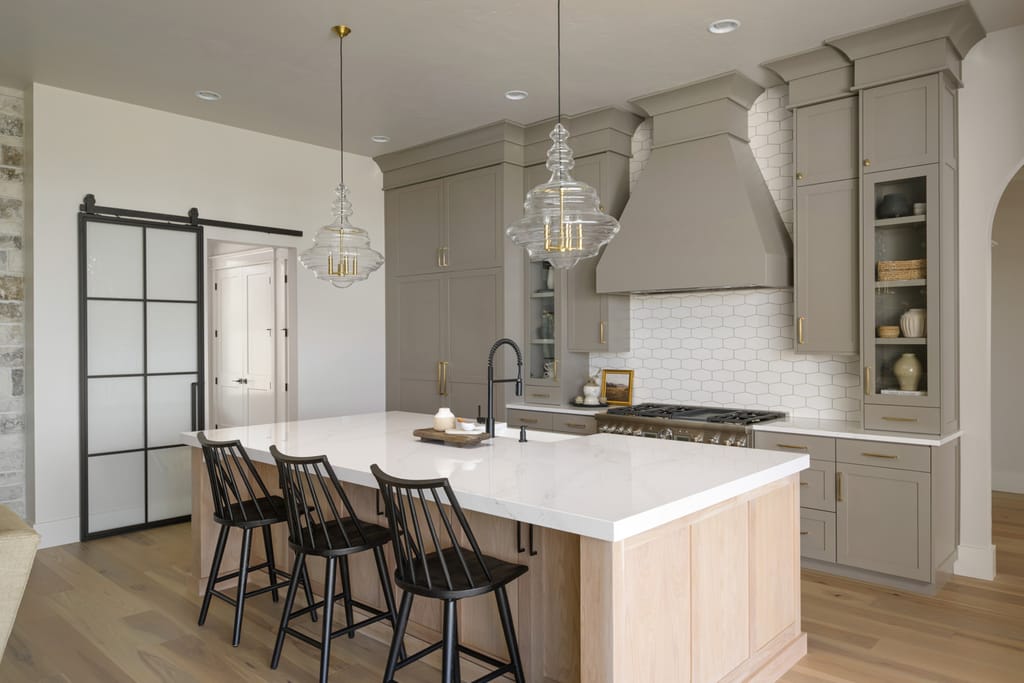 Modern kitchen with stone accent wall and large island in Boise Idaho luxury home