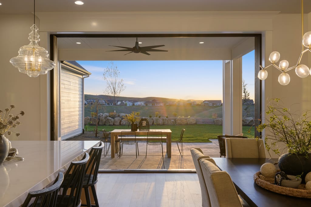 Spacious living room with ceiling fan and open patio views in Boise Idaho home