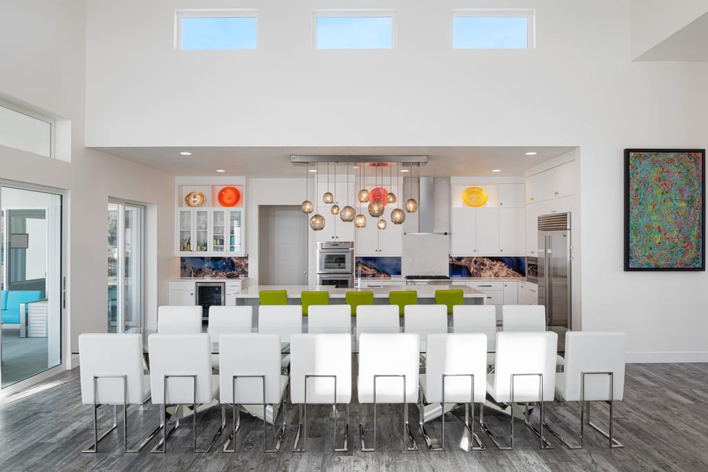 Contemporary open-concept living and dining room with dark floors in luxury Boise home