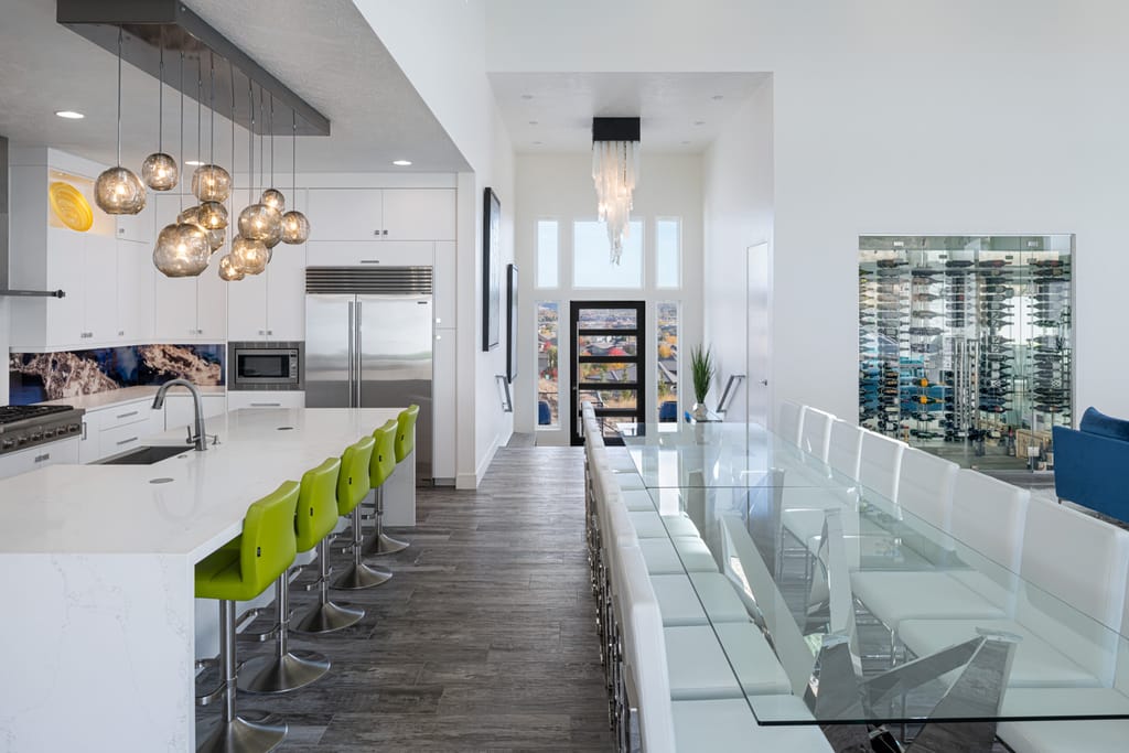 Modern white interior with turquoise pendant lights and open floor plan in Boise home