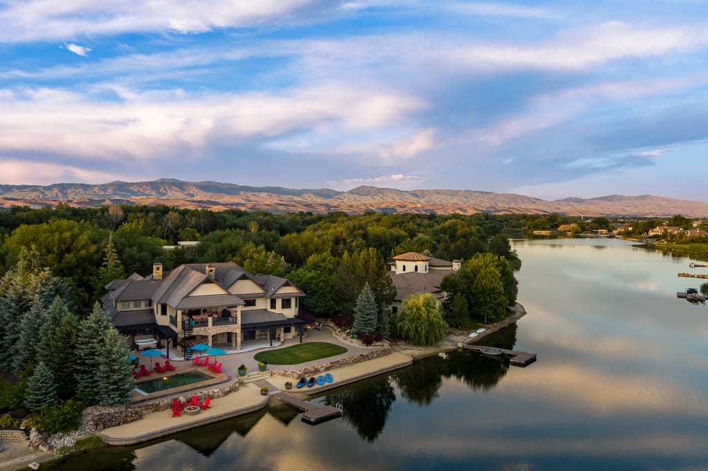 Luxury lakefront estate with pool dock and fire pit area in Idaho foothills