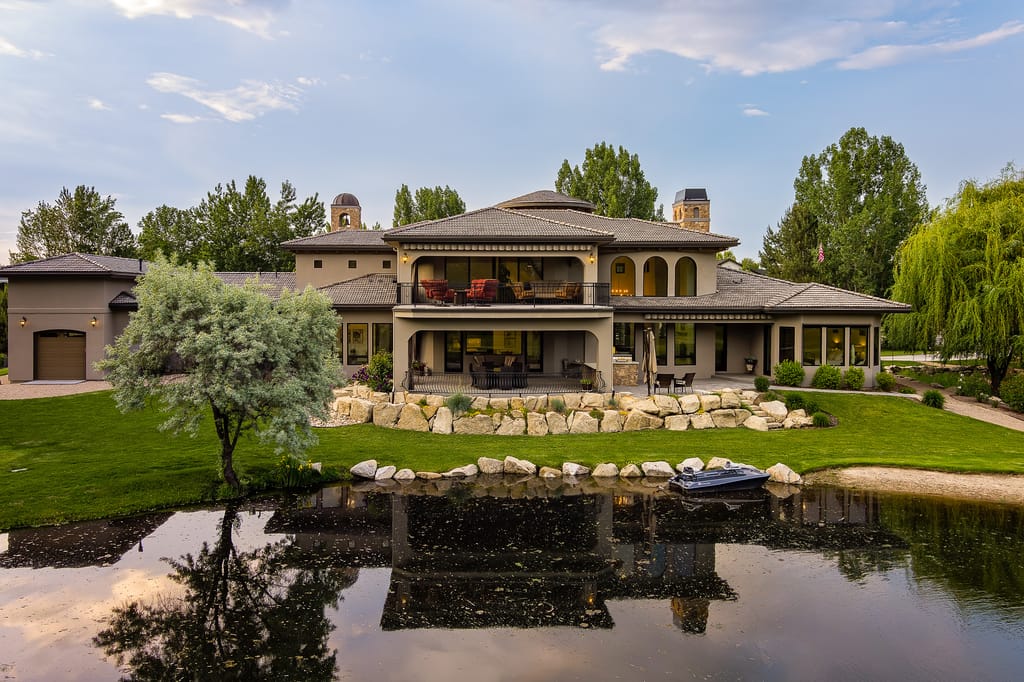 Aerial view of Mediterranean estate with pond and landscaped grounds in Idaho
