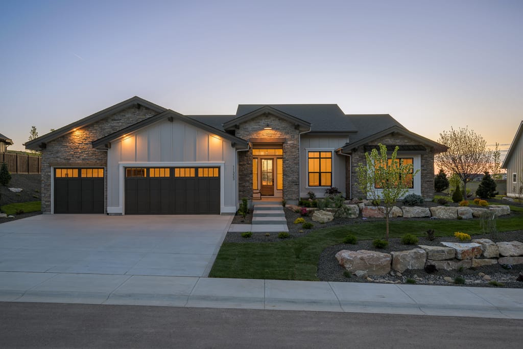 Stunning stone and wood luxury estate exterior at twilight in Eagle Idaho