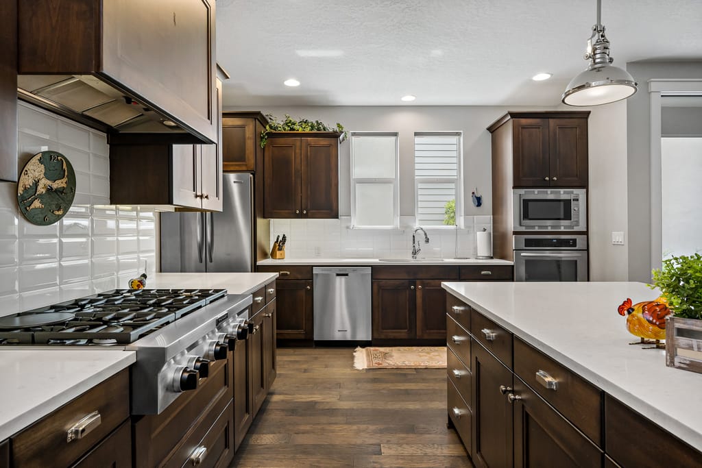 Craftsman style home exterior with stone accents and three-car garage in Eagle Idaho